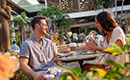 A couple dines together in the outdoor courtyard at Loews Royal Pacific Resort in Orlando.